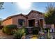 View of home's facade, showcasing stonework and drought-tolerant landscaping at 26653 W Firehawk Dr, Buckeye, AZ 85396