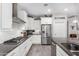 Modern white kitchen features granite countertops and stainless steel appliances at 26653 W Firehawk Dr, Buckeye, AZ 85396