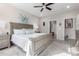 King-size bed in a spacious main bedroom with access to the ensuite bath at 26653 W Firehawk Dr, Buckeye, AZ 85396