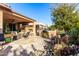 Outdoor patio with fireplace, seating area, and built-in grill at 26653 W Firehawk Dr, Buckeye, AZ 85396