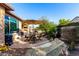 Backyard patio with seating area, umbrella, and gravel landscaping at 26653 W Firehawk Dr, Buckeye, AZ 85396