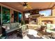 Relaxing patio with fireplace, seating area, and ceiling fan at 26653 W Firehawk Dr, Buckeye, AZ 85396