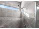 Walk-in shower with gray tile and a mosaic accent strip at 26653 W Firehawk Dr, Buckeye, AZ 85396