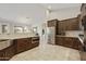 Modern kitchen with dark wood cabinets and stainless steel appliances at 28206 N 141St St, Scottsdale, AZ 85262