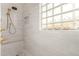 Modern shower with marble seat and glass block window at 4033 E Bruce Ave, Gilbert, AZ 85234