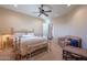Bright bedroom with a brass bed frame and sitting area at 5681 E Canyon Ridge North Dr, Cave Creek, AZ 85331