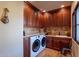 Laundry room with washer, dryer, and ample cabinetry at 5681 E Canyon Ridge North Dr, Cave Creek, AZ 85331