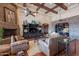 Spacious living room with leather sofas and a fireplace at 5681 E Canyon Ridge North Dr, Cave Creek, AZ 85331