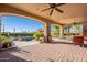 Covered patio with brick pavers, pool view, and ceiling fans at 5681 E Canyon Ridge North Dr, Cave Creek, AZ 85331