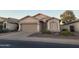 Single-story home with a two-car garage and well-maintained landscaping at 6154 W Echo Ln, Glendale, AZ 85302