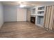 Living room with fireplace, wood-look floors, and light blue walls at 6154 W Echo Ln, Glendale, AZ 85302