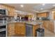 Large kitchen with granite countertops and stainless steel appliances at 6974 S Hohokam Pl, Gold Canyon, AZ 85118