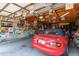 Attached garage with various car-themed decor and a red Mazda Miata at 7000 N Via Camello Del Sur -- # 37, Scottsdale, AZ 85258