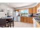 Bright kitchen with wood cabinets, granite counters, and a breakfast nook at 7000 N Via Camello Del Sur -- # 37, Scottsdale, AZ 85258