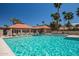 Inviting community pool with surrounding lounge chairs and palm trees at 7000 N Via Camello Del Sur -- # 37, Scottsdale, AZ 85258