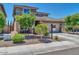 Two-story house with a beige exterior, landscaped front yard, and a two-car garage at 8953 W Townley Ave, Peoria, AZ 85345