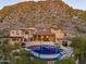 Luxury estate home with a large pool and mountain backdrop at 10040 E Happy Valley Rd # 512, Scottsdale, AZ 85255