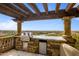 Outdoor kitchen with pergola, grill, and mountain views at 10040 E Happy Valley Rd # 512, Scottsdale, AZ 85255
