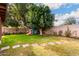 Landscaped backyard with grassy area, trees, and playset at 102 S Valle Verde --, Mesa, AZ 85208