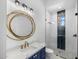 Stylish bathroom with a navy blue vanity and gold mirror at 11438 N 70Th St, Scottsdale, AZ 85254