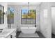 Elegant bathroom featuring a freestanding tub, walk-in shower, and marble tile at 11438 N 70Th St, Scottsdale, AZ 85254