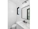 Modern bathroom with white wave patterned tile and black fixtures at 11438 N 70Th St, Scottsdale, AZ 85254