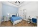 Light and airy bedroom with a cozy bed, built-in desk, and wood floors at 11438 N 70Th St, Scottsdale, AZ 85254