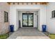 Inviting entryway with double doors, blue planters, and a welcoming sign at 11438 N 70Th St, Scottsdale, AZ 85254