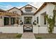 Farmhouse exterior with pergola, landscaping, and gated entry at 11438 N 70Th St, Scottsdale, AZ 85254