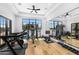Well-equipped home gym with various exercise machines and a large mirror at 11438 N 70Th St, Scottsdale, AZ 85254