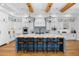Modern kitchen with white cabinets, blue island, and hardwood floors at 11438 N 70Th St, Scottsdale, AZ 85254