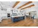 Open concept kitchen with large island, white cabinets, and hardwood floors at 11438 N 70Th St, Scottsdale, AZ 85254