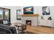 Living room with a cozy fireplace and hardwood floors at 11438 N 70Th St, Scottsdale, AZ 85254