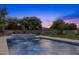 Luxury pool with spa and fountain at dusk at 11438 N 70Th St, Scottsdale, AZ 85254