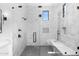 Spa-like shower with marble tile and built-in bench at 11438 N 70Th St, Scottsdale, AZ 85254
