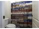 Small bathroom with toilet and patterned shower curtain at 1340 E Kingman Pl, Casa Grande, AZ 85122