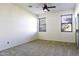 Well-lit bedroom with neutral carpeting and ceiling fan at 1340 E Kingman Pl, Casa Grande, AZ 85122