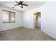 Bedroom with ceiling fan and access to another room at 1340 E Kingman Pl, Casa Grande, AZ 85122