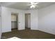 Bright bedroom with ceiling fan, walk-in closet, and neutral carpeting at 1340 E Kingman Pl, Casa Grande, AZ 85122