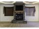 Stone fireplace with a large mantle and built in shelving at 1340 E Kingman Pl, Casa Grande, AZ 85122