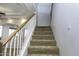 Staircase with carpeted steps and wooden railing at 1340 E Kingman Pl, Casa Grande, AZ 85122
