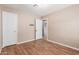 Well-lit bedroom featuring wood-look floors and closet at 1340 W Romley Rd, Phoenix, AZ 85041