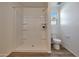 Clean bathroom with shower/tub combo, toilet and built-in shelving at 1360 W Inca Dr, Coolidge, AZ 85128