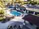 Aerial view of a house featuring a sparkling pool, a spacious patio, and fire pit at 1440 E Secretariat Dr, Tempe, AZ 85284