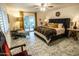 Main bedroom with a plush bed, patterned rug, and access to a patio at 1440 E Secretariat Dr, Tempe, AZ 85284