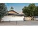 Modern two-car garage with a clean, white exterior and landscaping at 1440 E Secretariat Dr, Tempe, AZ 85284