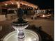Elegant stone fountain in the backyard, surrounded by lush landscaping at 1440 E Secretariat Dr, Tempe, AZ 85284