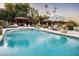Inviting pool area with a pergola, lounge chairs, and lush landscaping at 1440 E Secretariat Dr, Tempe, AZ 85284