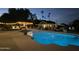 Inviting swimming pool with a pergola, lounge chairs, and festive lighting at night at 1440 E Secretariat Dr, Tempe, AZ 85284