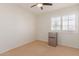 Small bedroom with mini-fridge and window shutters at 1571 W Orchid Ln, Chandler, AZ 85224